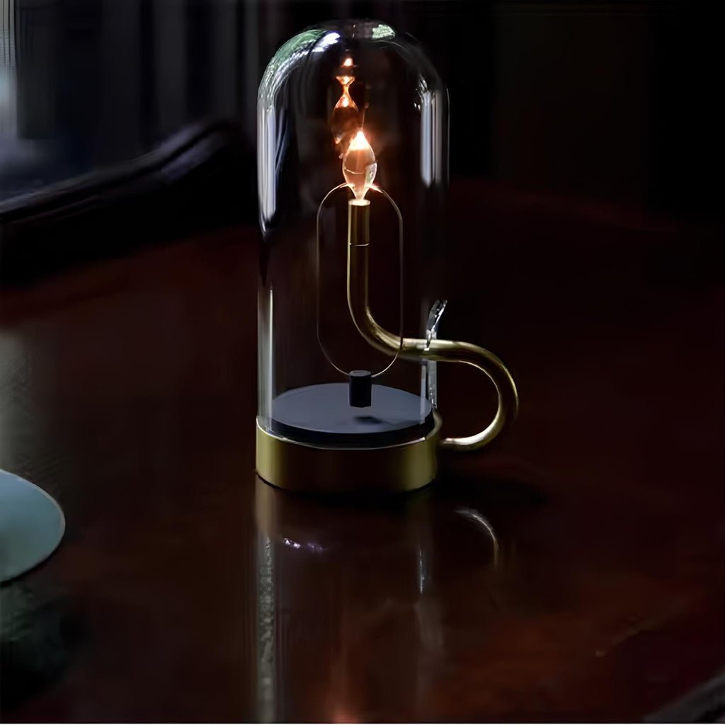LED-bordslampa i glas — kinetiskt svängande hölje, magnetisk pendellampa